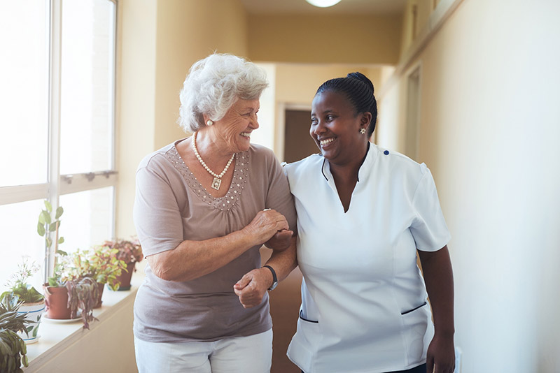 Home Health nursing helping a woman walk
